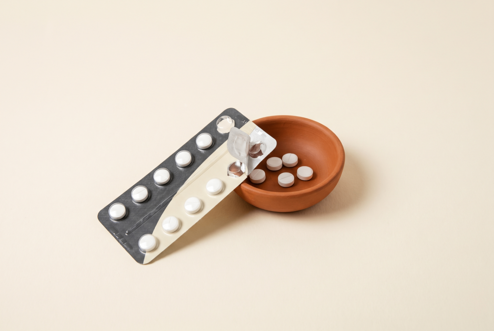 Blister pack and pills in a terracotta dish
