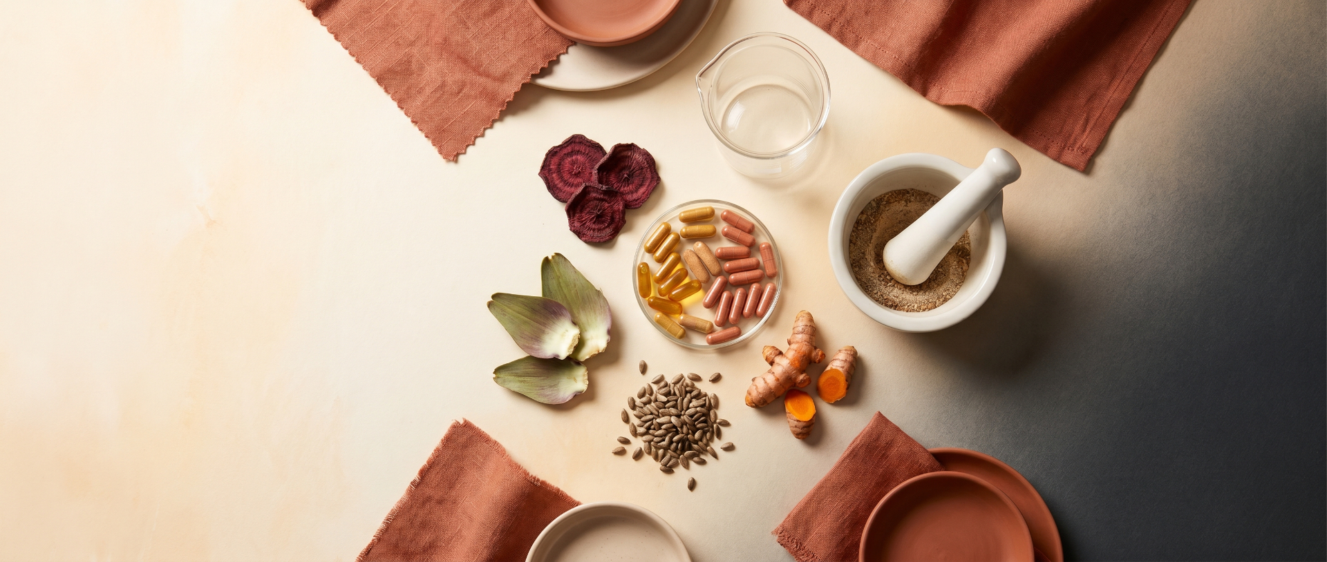 Flat lay of Brixen Clear capsules with beetroot, turmeric, milk thistle, and artichoke on a warm cream surface